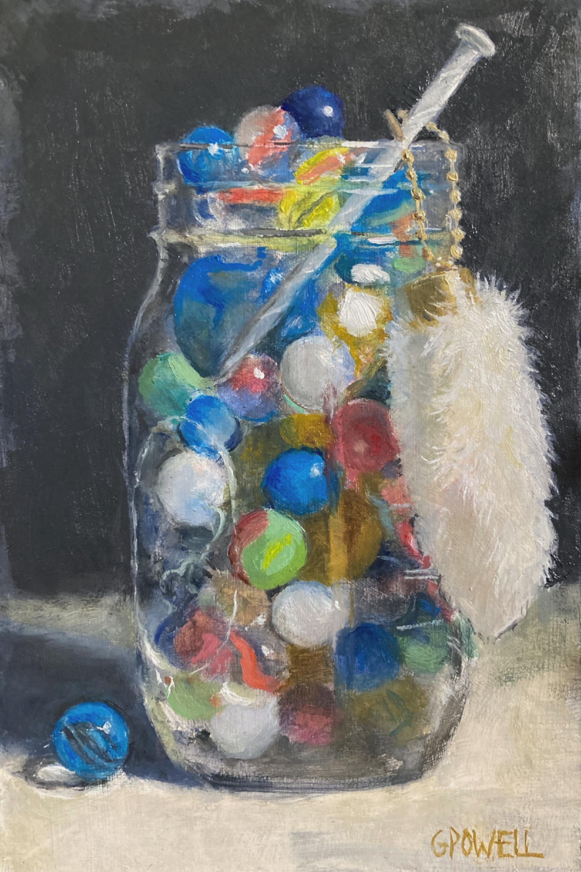 A small, colorful still life painting of a jar of marbles and a nail. A lucky rabbit's foot hangs from the nail.