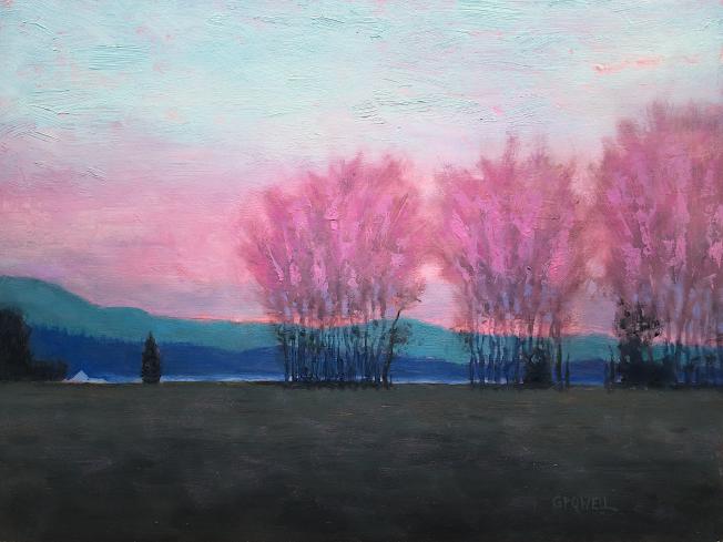 Poplars silhouetted against a vibrant pink sunset over Mary's Peak in the Willamette Valley.