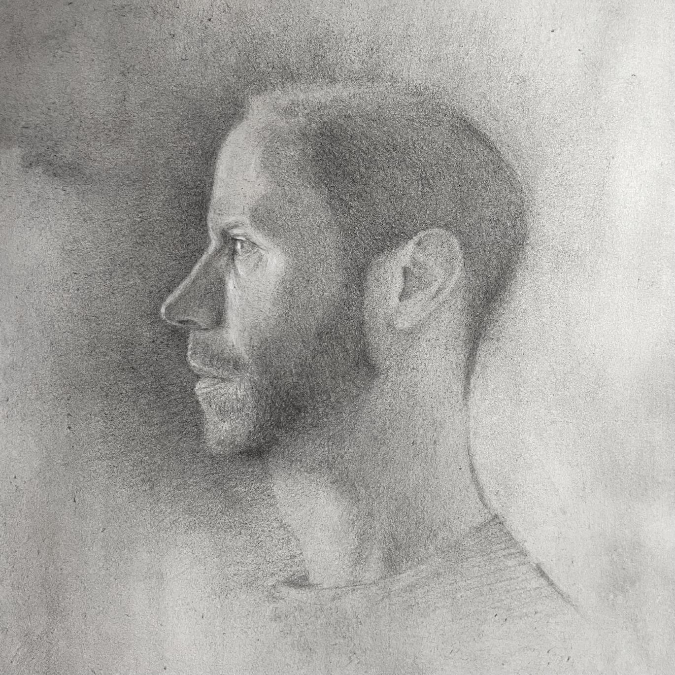 Realistic self portrait drawing in pencil, in profile. Shaded lightly and on paper toned with India ink. It has a slightly ethereal quality.
