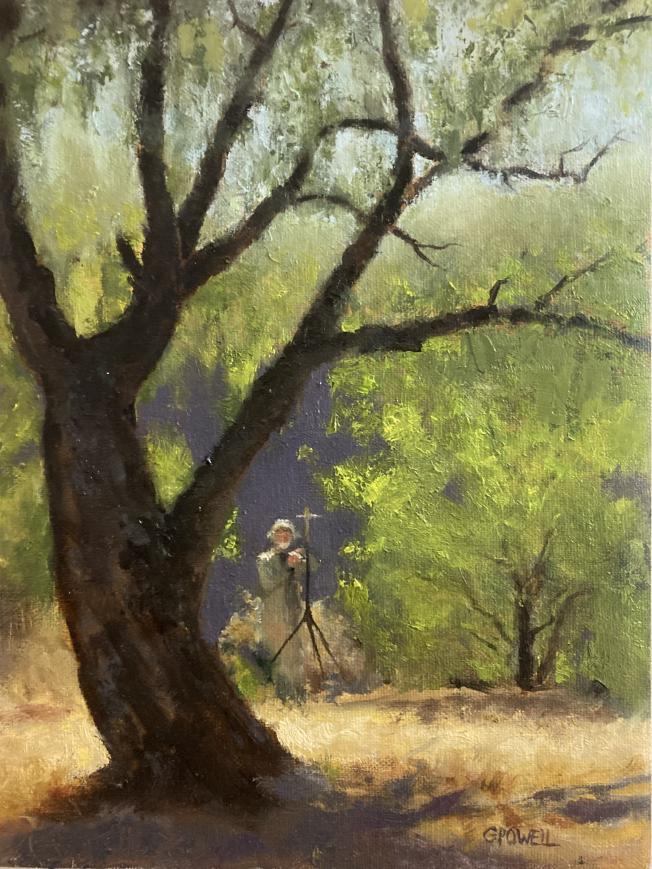 A figure of a man stands in the shrubs, framed by a backlit tree. The light is warm and penetrating.